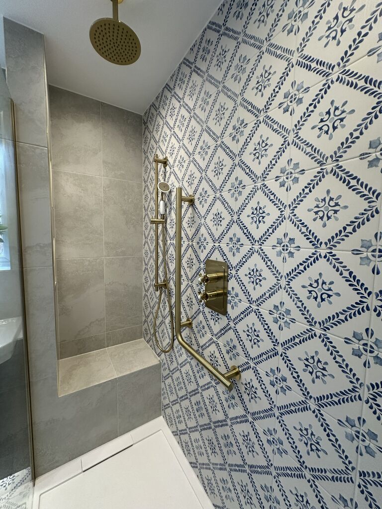 Tiled shower bench running wall to wall with brushed brass slide rail and grab rail Kelvedon CO5 Essex