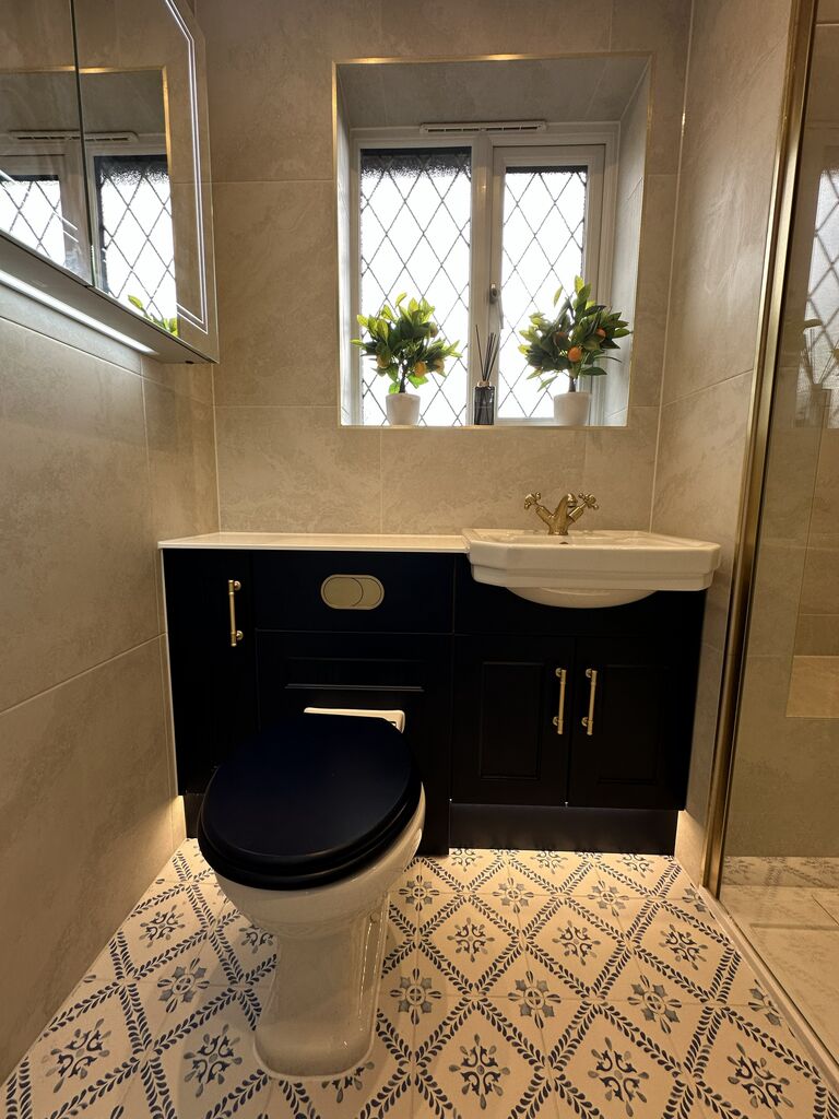 Traditional ceramic basin with brushed brass cross-head mixer on navy Calypso Pentland furniture Kelvedon CO5 Essex