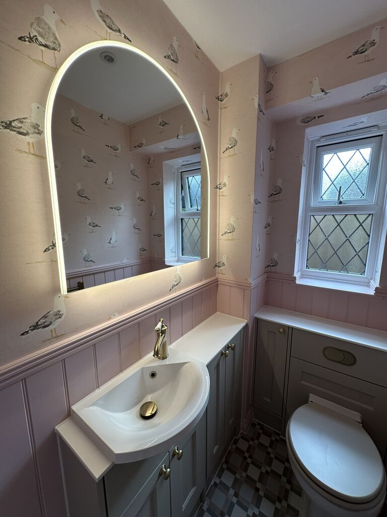 Arched HiB LED mirror above fitted cloakroom furniture with tongue-and-groove panelling Kelvedon CO5 Essex