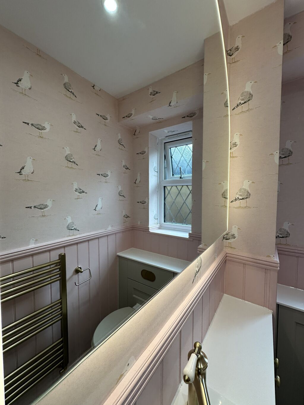 Leaded cottage window above the white worktop in a pink and sage cloakroom Kelvedon CO5 Essex