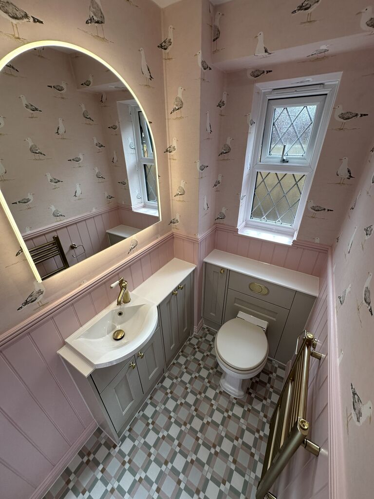 Calypso Pentland Portland Stone vanity with brushed brass tap under an arched LED mirror Kelvedon CO5 Essex cloakroom