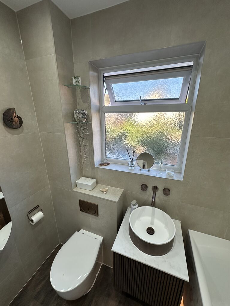 Back-to-wall WC and fluted walnut vanity by the window Kelvedon CO5 Essex family bathroom