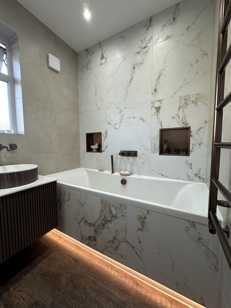 LED-underlit bath against calacatta marble-look porcelain Kelvedon CO5 Essex family bathroom