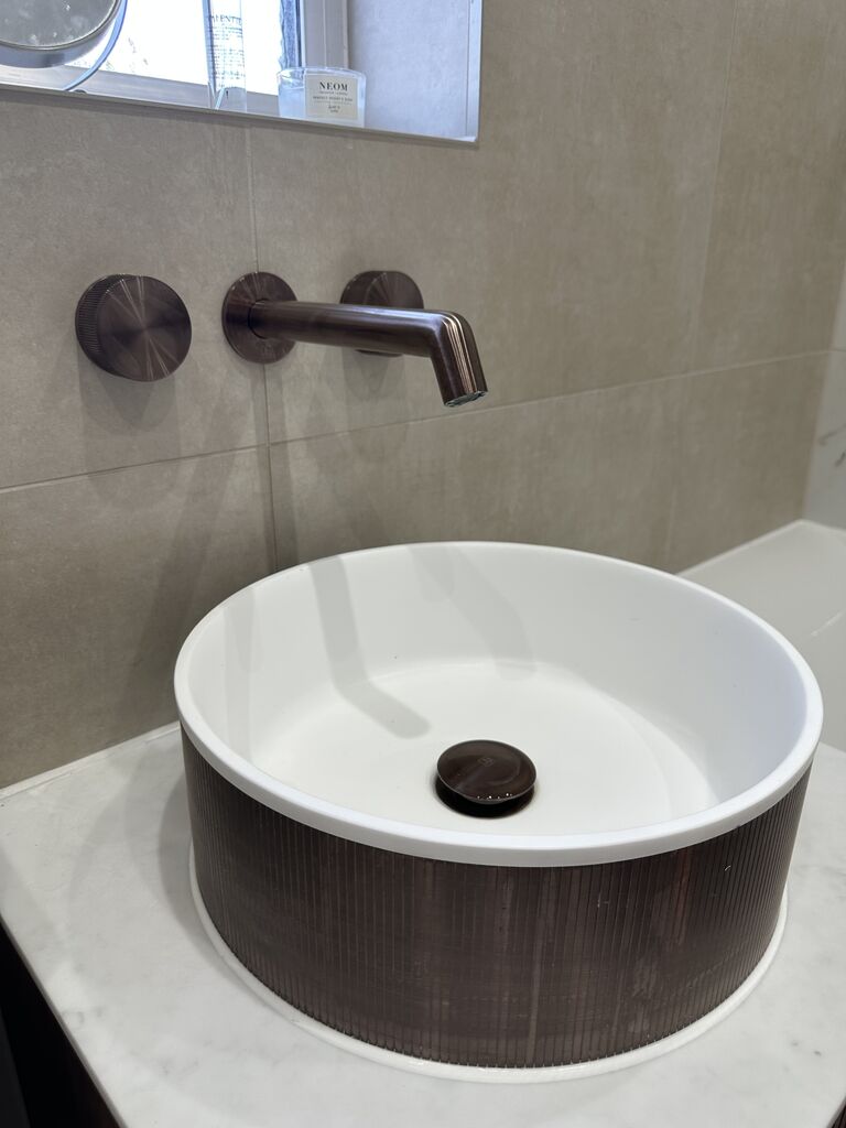 Round fluted countertop basin with wall-mounted brushed bronze taps Kelvedon CO5 Essex