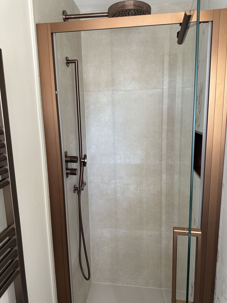 Bronze shower door frame and rain head over the enclosure Kelvedon CO5 Essex master ensuite