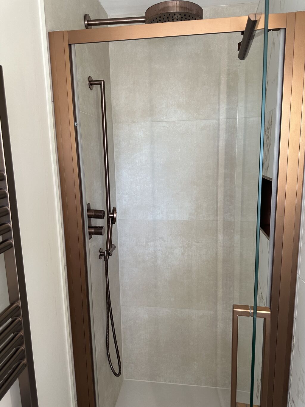 Bronze shower door frame and rain head over the enclosure Kelvedon CO5 Essex master ensuite