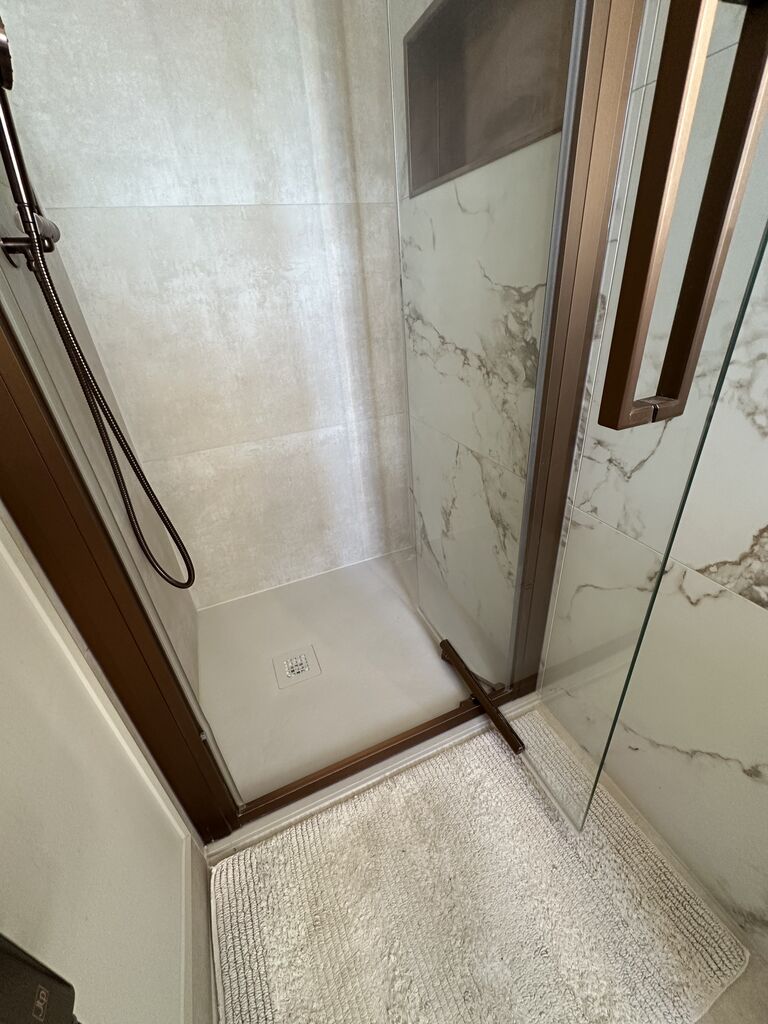 White shower tray inside the bronze-framed enclosure Kelvedon CO5 Essex master ensuite