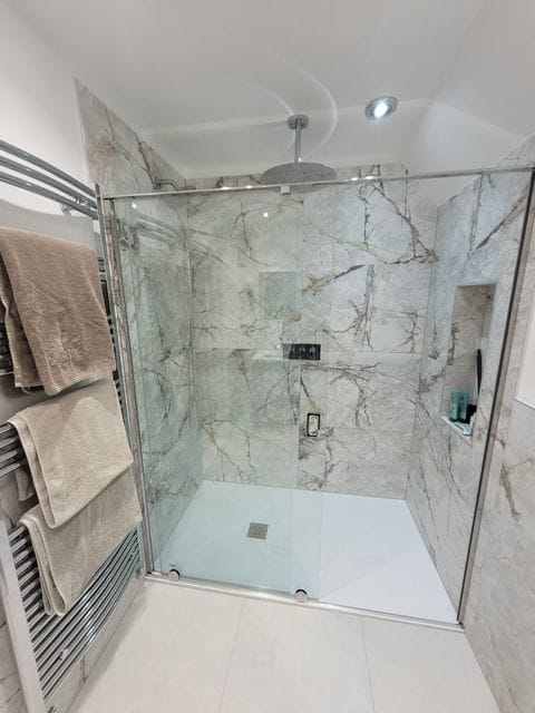 Walk-in shower with ceiling rain head and Ca' Pietra marble tiles Tiptree CO5 luxury master ensuite