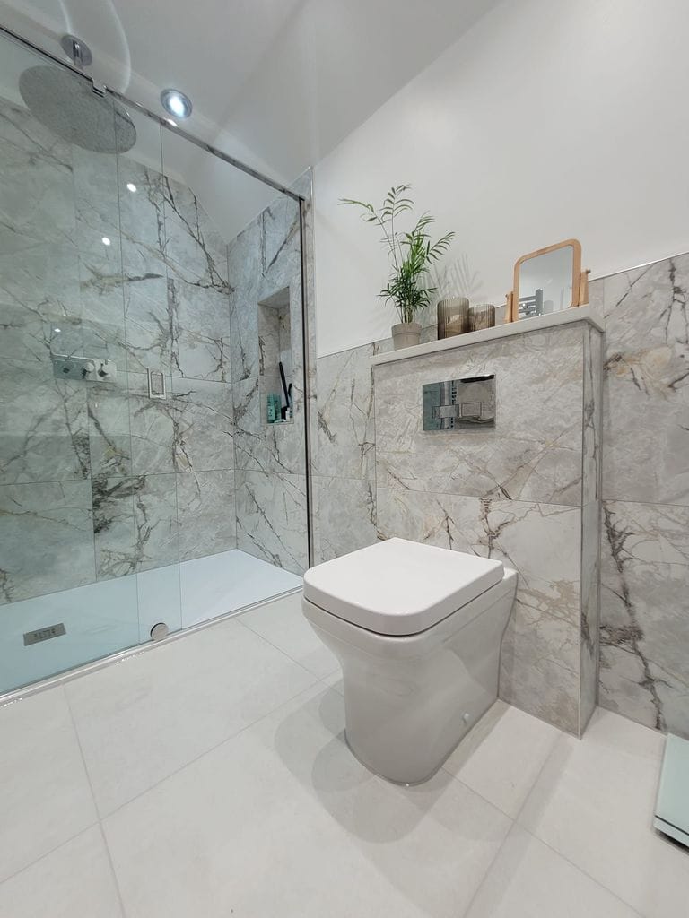 Full room view showing walk-in shower WC and Ca' Pietra marble tiled walls Tiptree CO5 Essex