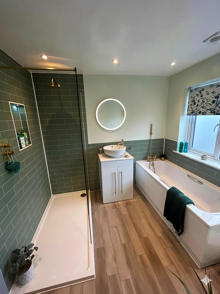 Completed family bathroom with Fibo sage green panels JTP brushed brass fixtures and HiB LED mirror West Mersea CO5 Essex