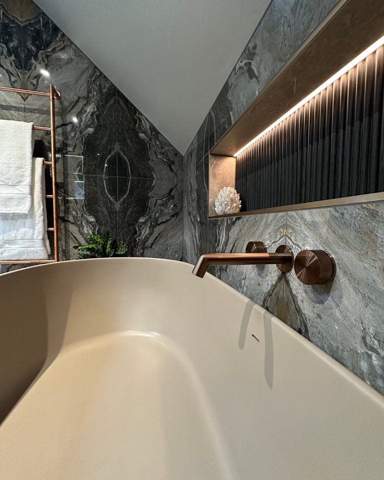 JTP Evo brushed bronze bath filler Vogue UK copper towel radiator and LED-lit ribbed niche West Mersea CO5