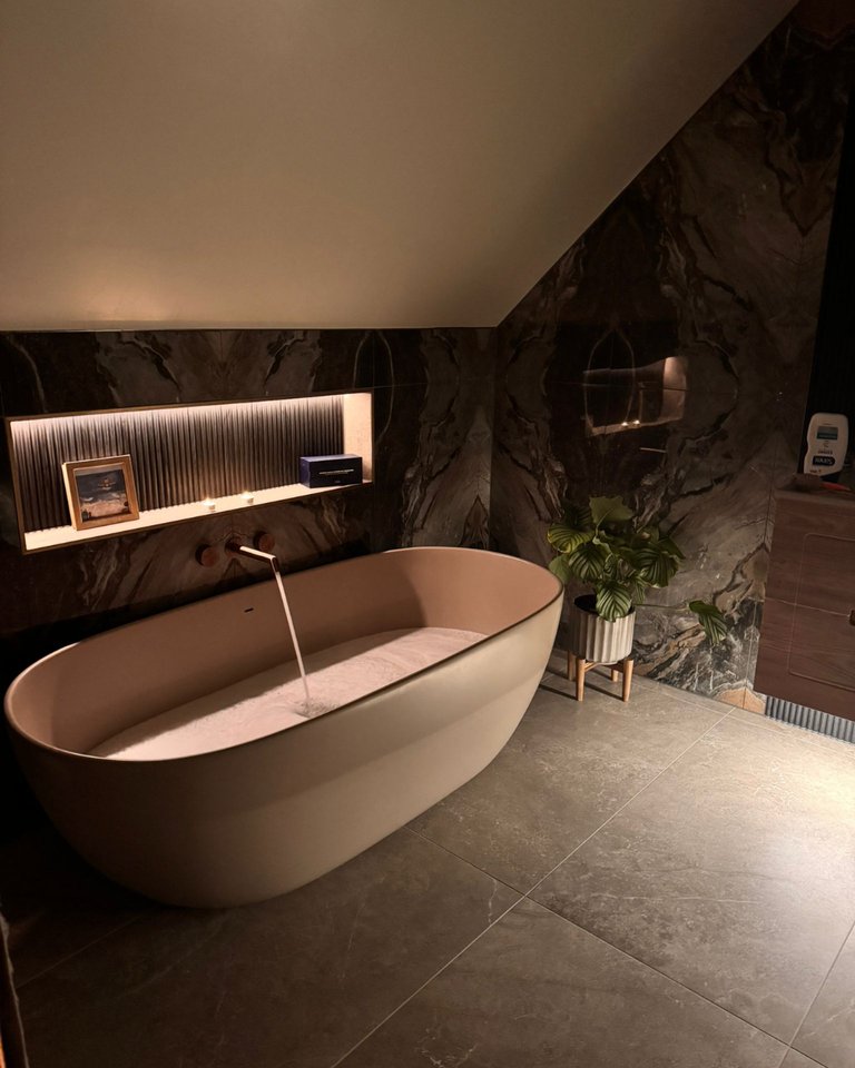 BC Designs Crea freestanding bath in Light Fawn with JTP Evo brushed bronze wall filler and LED niche West Mersea CO5