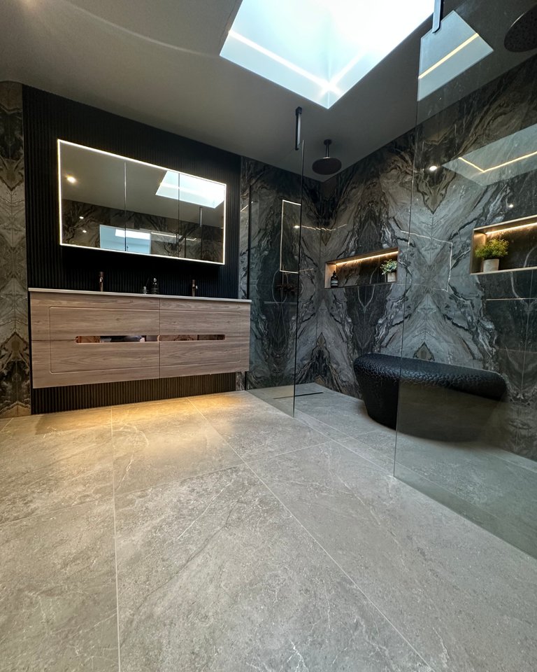 Skylight over the West Mersea CO5 wetroom with floating Ambiance Bain vanity, LED mirror cabinet and bookmatched Magnifique Nero walls