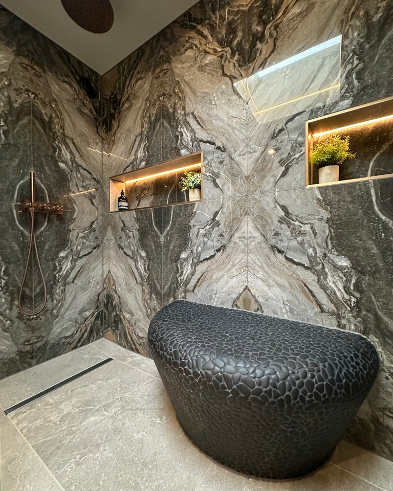 Porcelanosa Boulder Black pebble bench with heated seat between dual showers bookmatched tiles West Mersea CO5