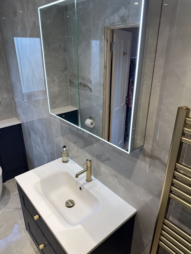 Backlit LED mirror above wall-hung basin with JTP brushed brass mixer Wickham Bishops CM8 Essex