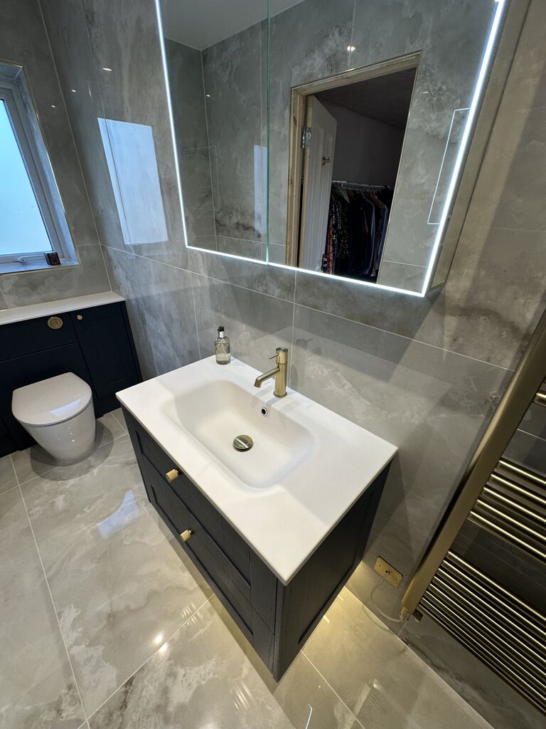 Navy Calypso Chiltern fitted vanity with backlit LED mirror and brushed brass towel radiator Wickham Bishops CM8 Essex